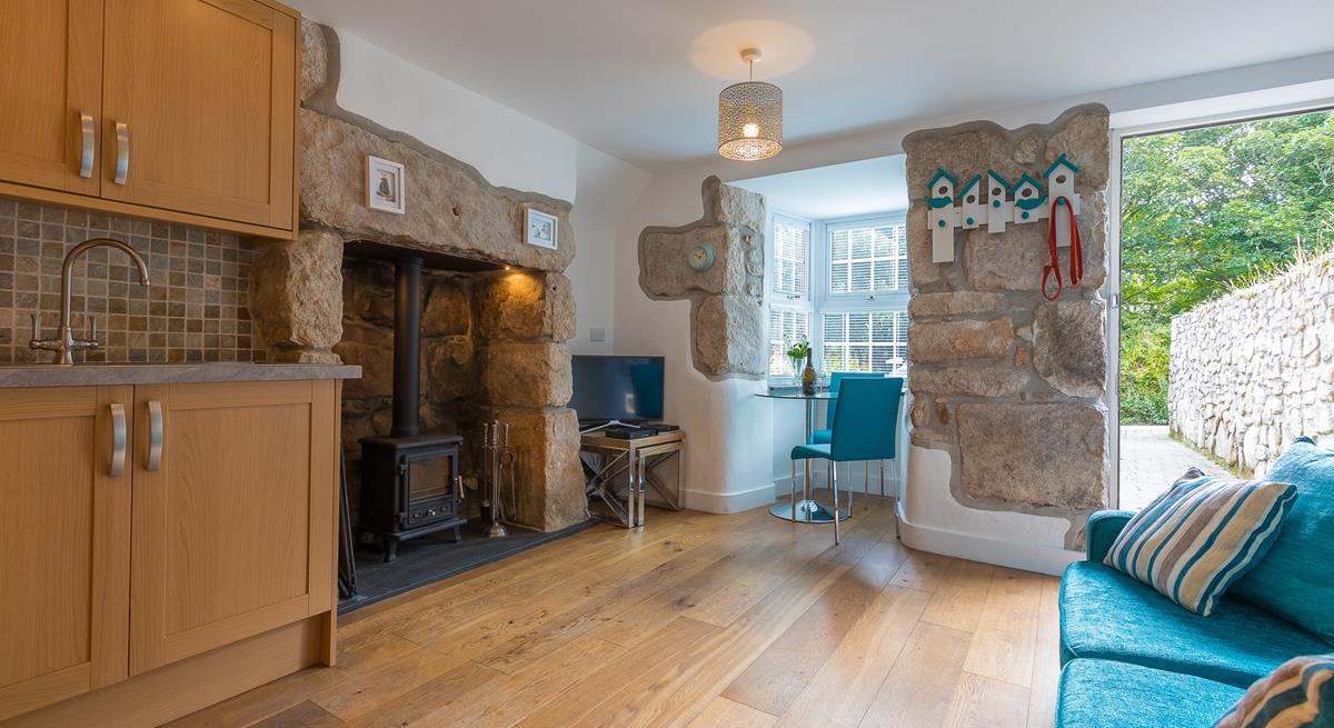 The Cornish granite inglenook fireplace features a woodburner, perfect for those cooler evenings. 