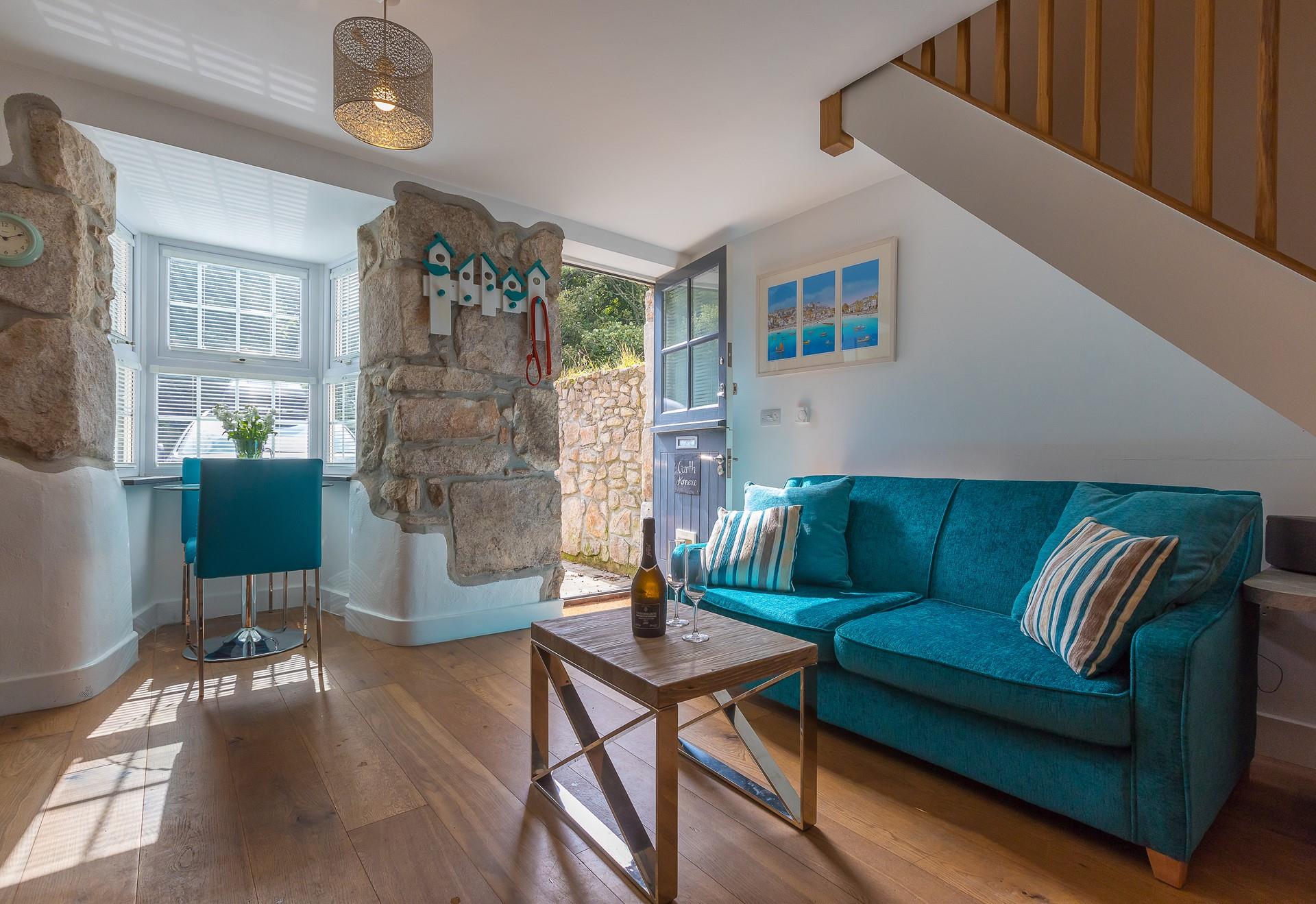 Exposed granite walls, wooden flooring and a stable door create a quaint cottage feel at Garth Annexe.