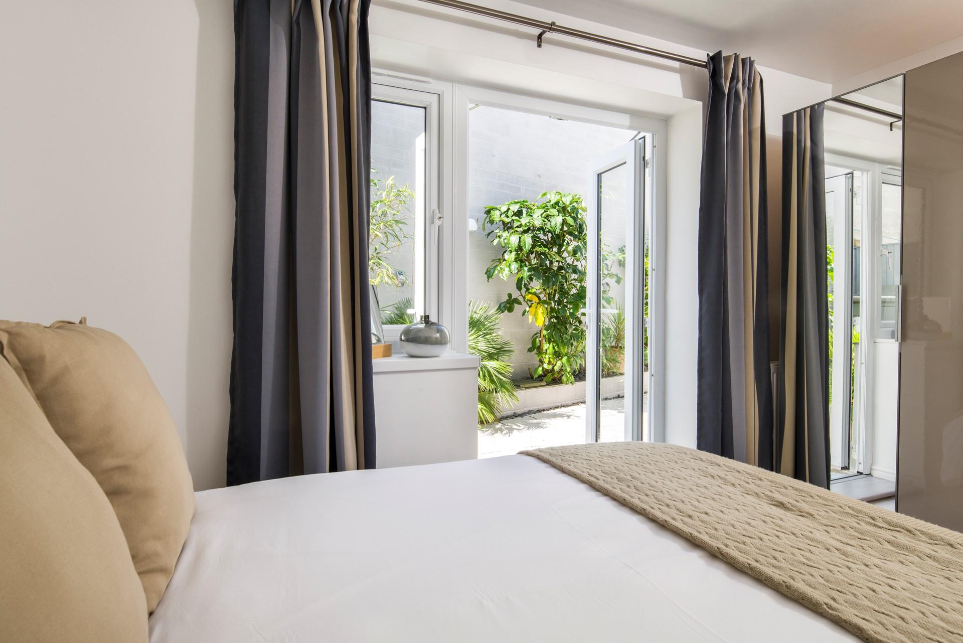 Wake up and let the sun shine on you in this light and airy bedroom.