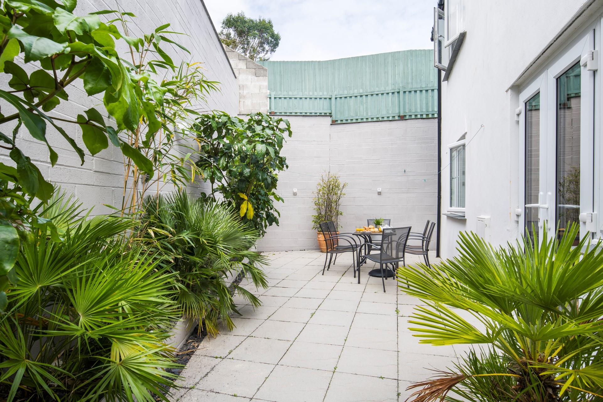 The green foliage creates a tropical feel on the private patio. 