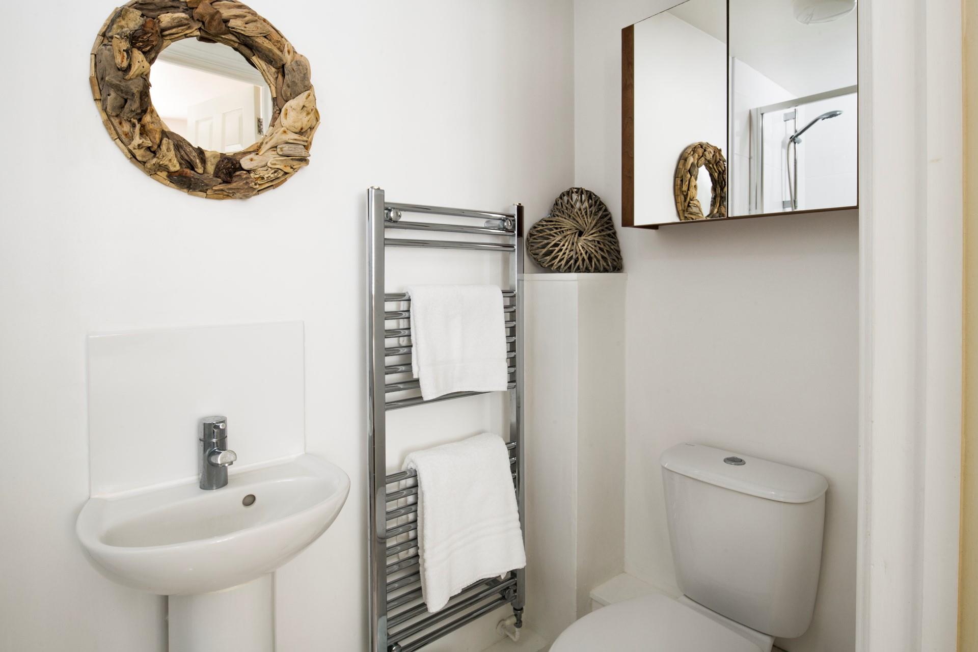 We love that the coastal artwork has been thoughtfully carried through to the bathroom. 