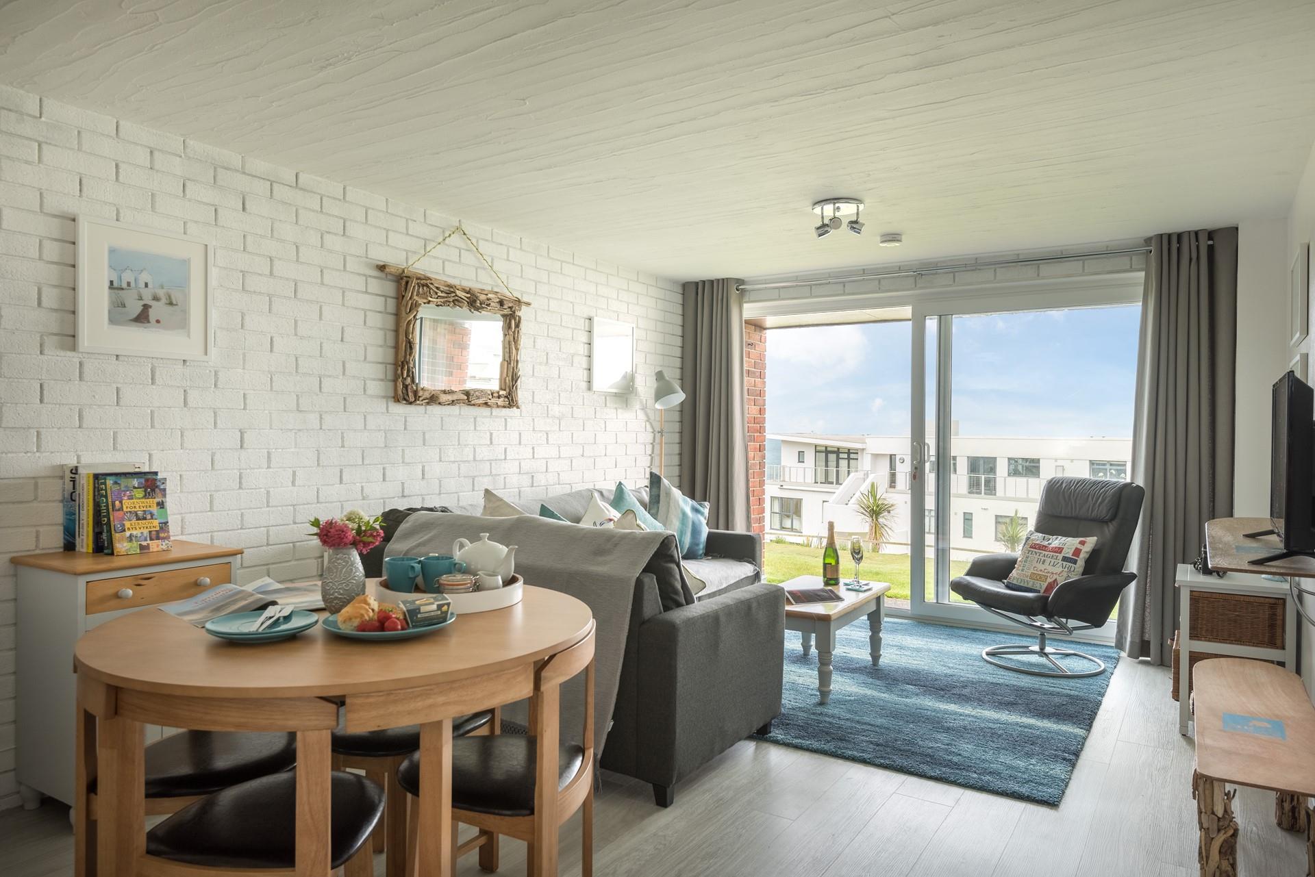 The living area is open plan and has large doors to the outside area, perfect for opening on sunny days and letting in the sea air.