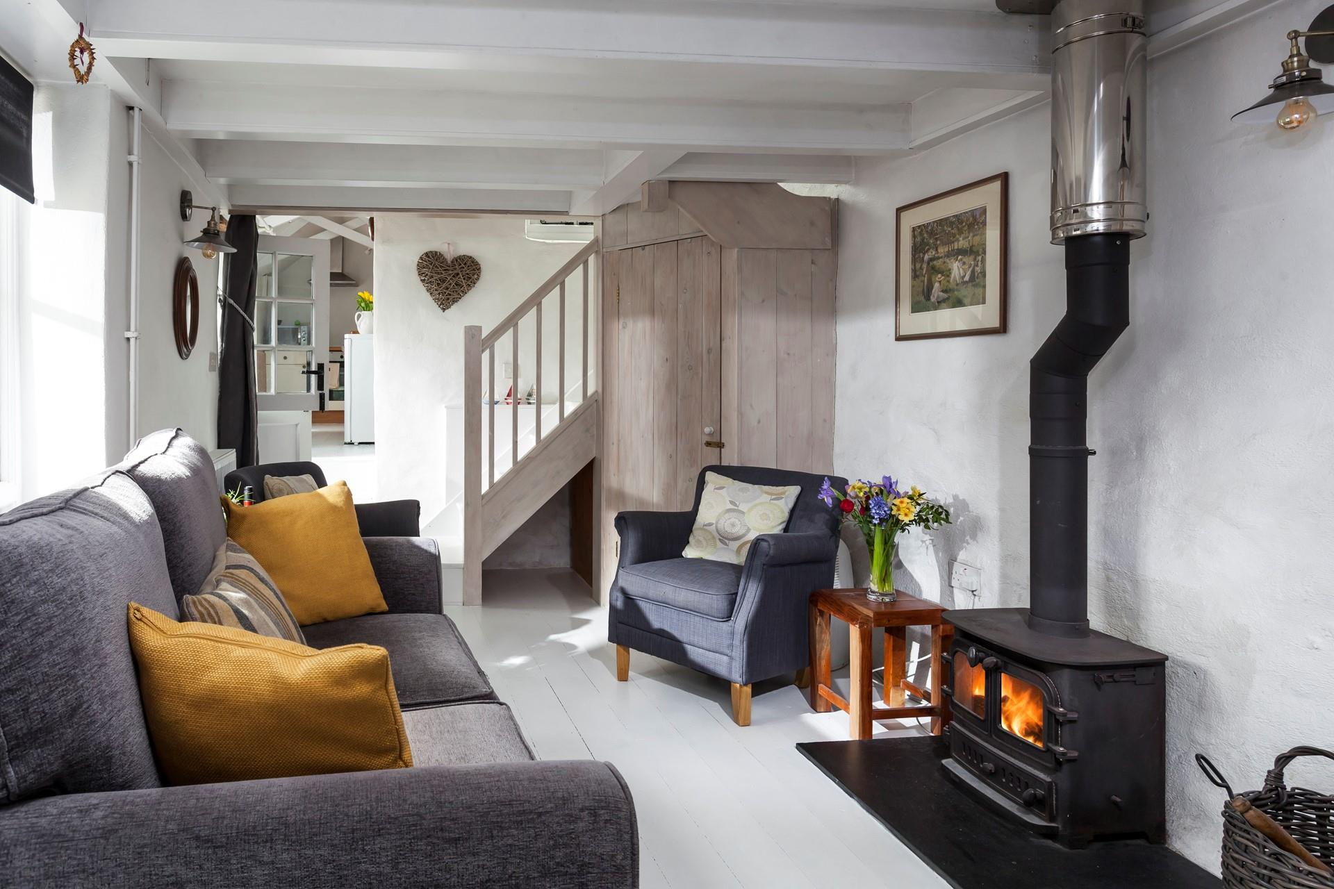 The cosy and quirky sitting room is perfect for snuggling up in front of the woodburner.