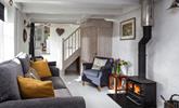 The cosy and quirky sitting room is perfect for snuggling up in front of the woodburner. - Thumbnail Image