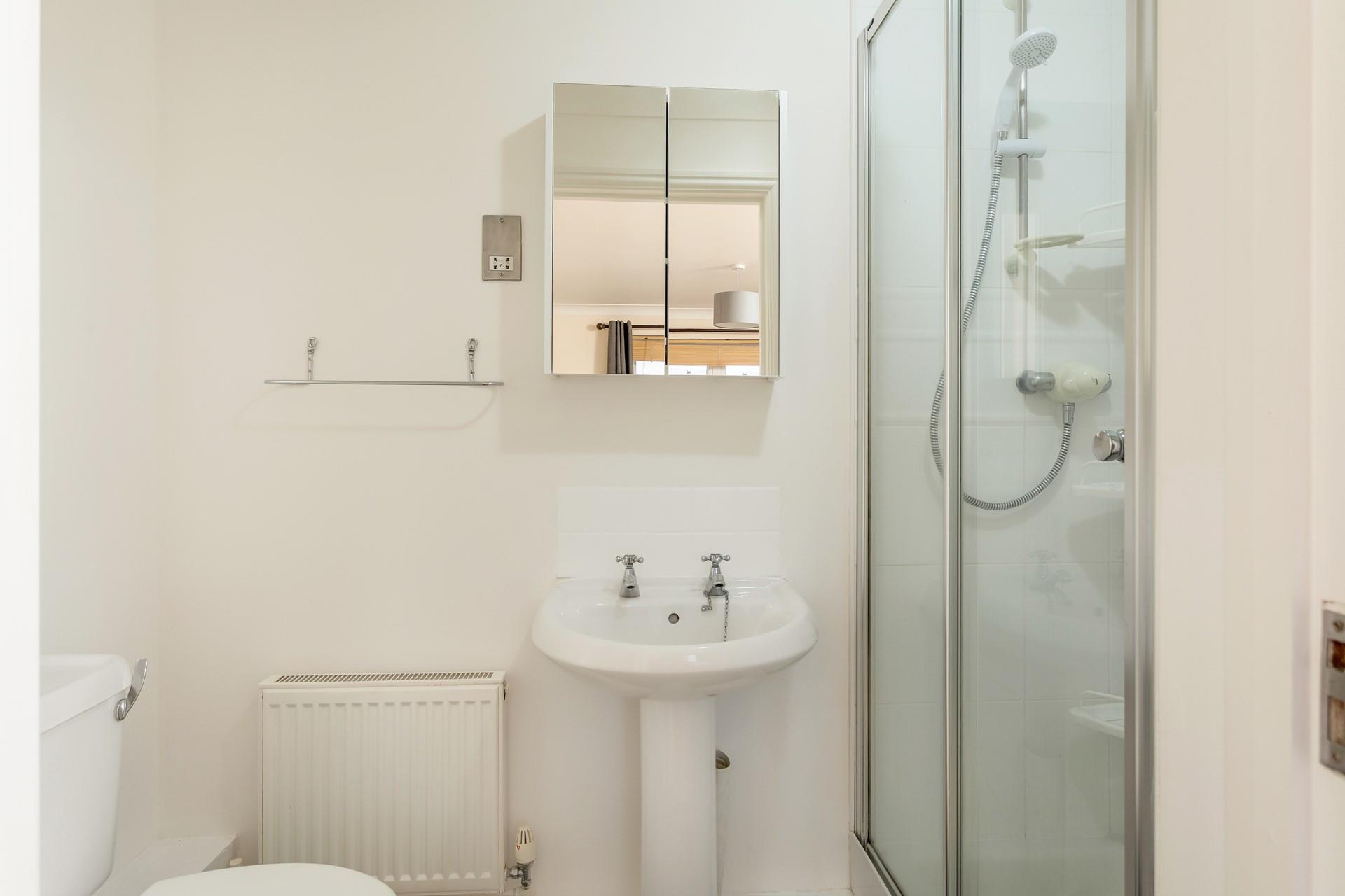 The master bedroom has an en suite shower room, offering space and privacy to get ready.