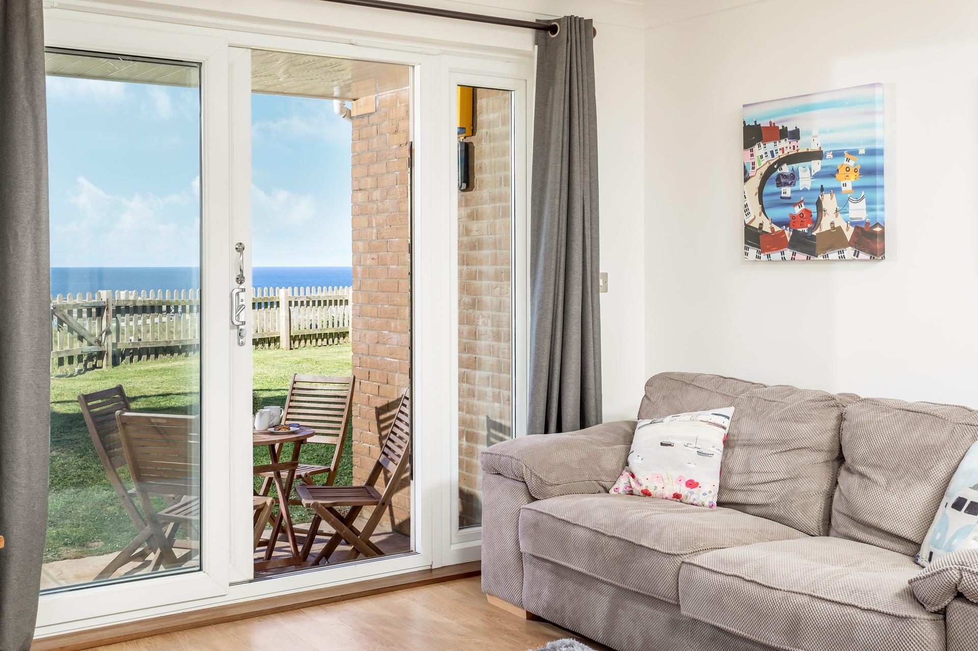 The comfortable sitting area has patio doors that lead to the outside space.