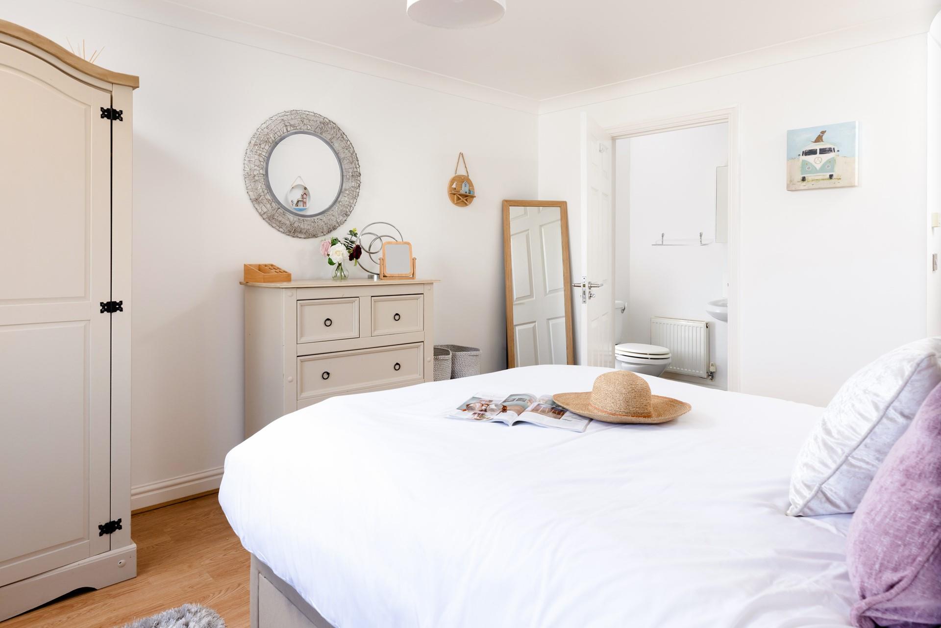Bedroom 1 has a comfortable king size bed and own en suite with views of the sea and headland. 