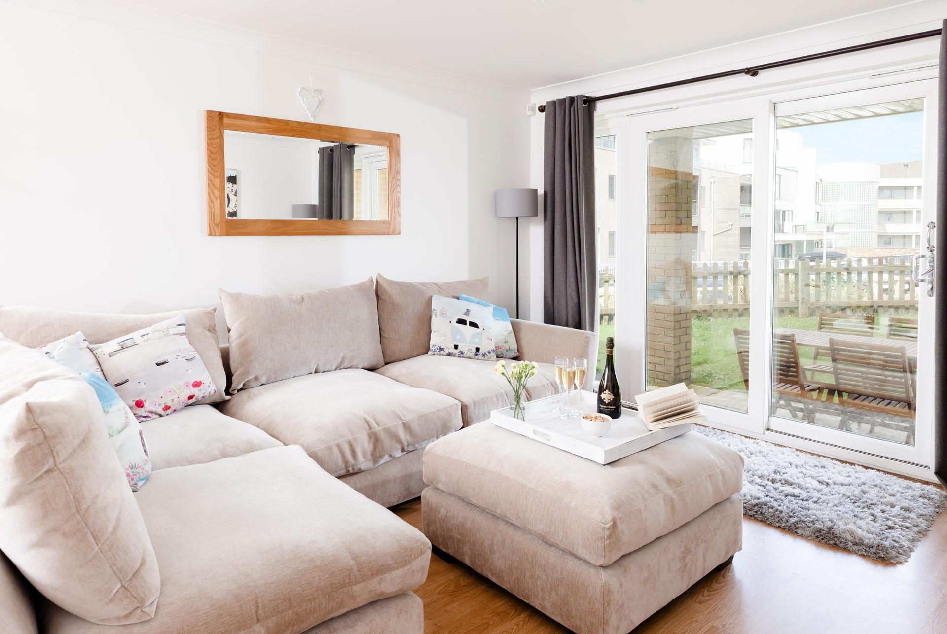 The comfortable sitting area has patio doors that lead to the outside space.
