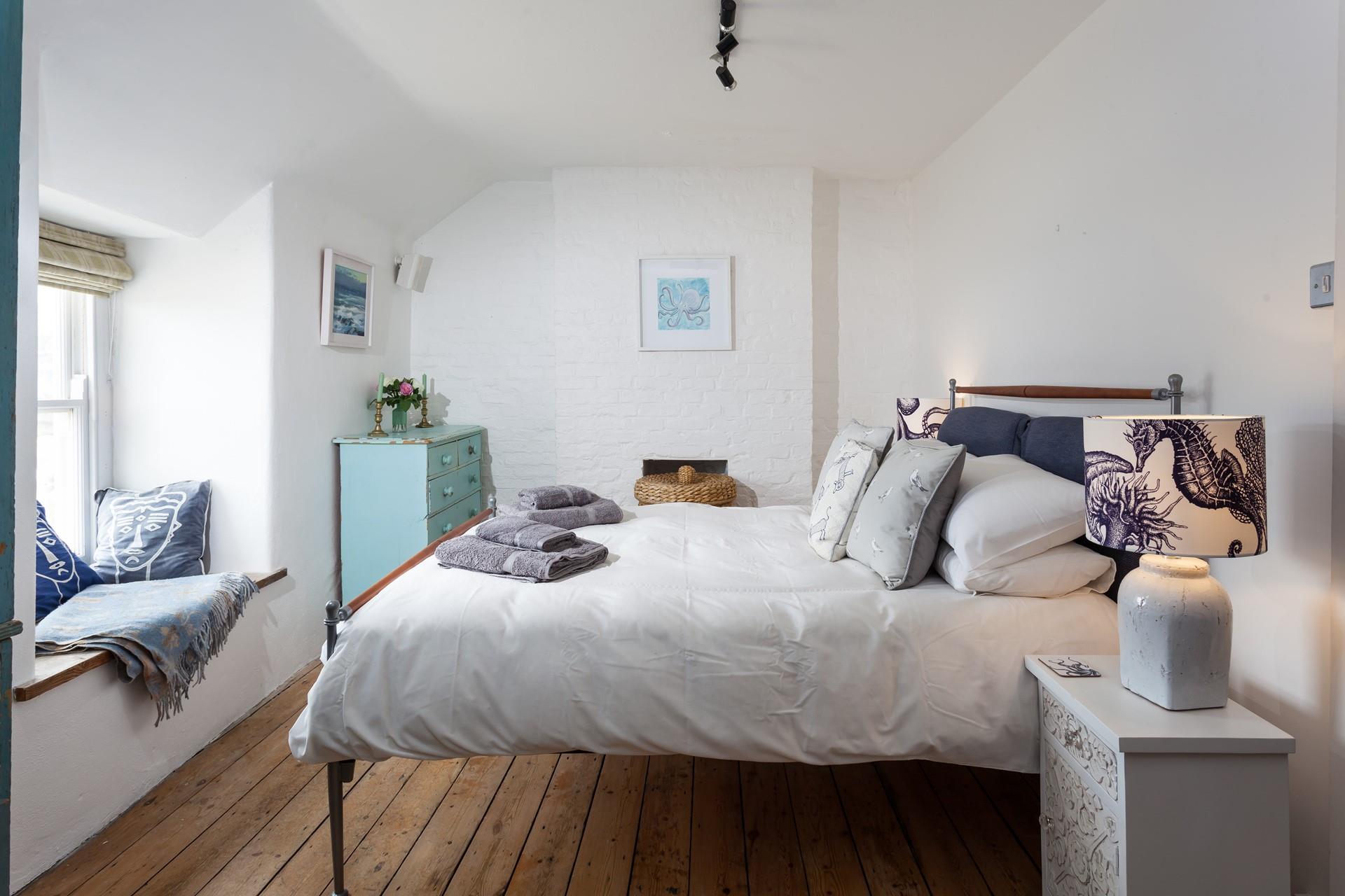 Bedroom 1 has a cosy feel with a large king size bed that promises a perfect night's sleep.