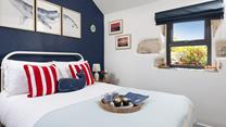 Bedroom 1 has a comfortable double bed and looks out to the garden.