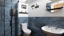 Contemporary and chic, the wet room has a walk-in shower.