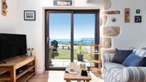 Patio doors frame the beautiful seascape and take you straight into the garden.