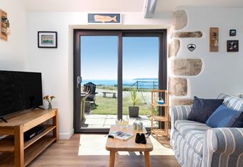 Patio doors frame the beautiful seascape and take you straight into the garden.
