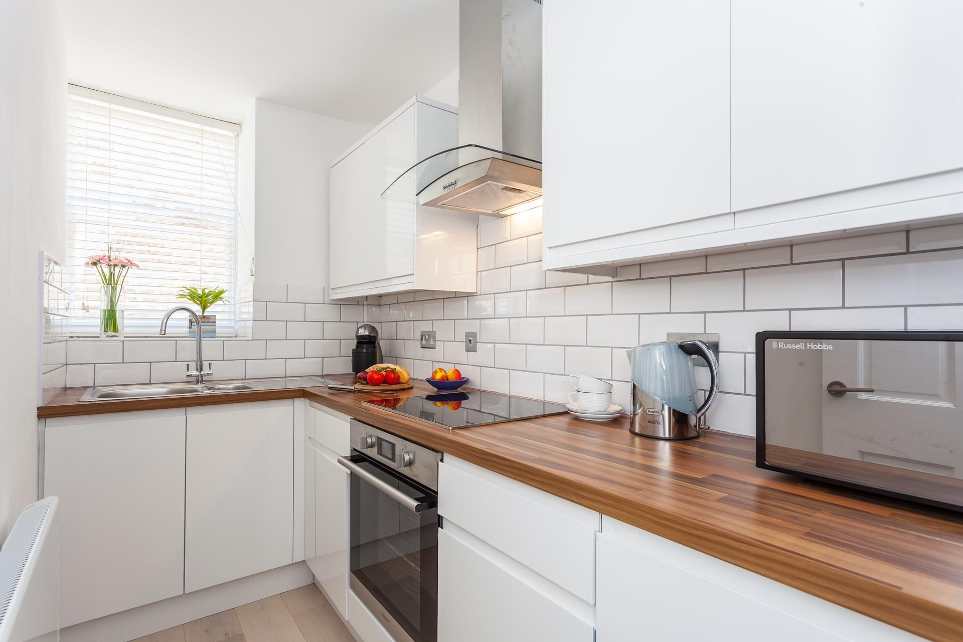 The sleek kitchen has all you need for a relaxing stay.