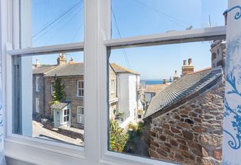 The view from the master bedroom looks through rooftops and over Mounts Bay towards the Lizard Peninsular.