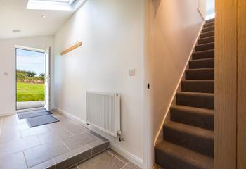 The utility area leads directly outside and has stairs to the first floor. 