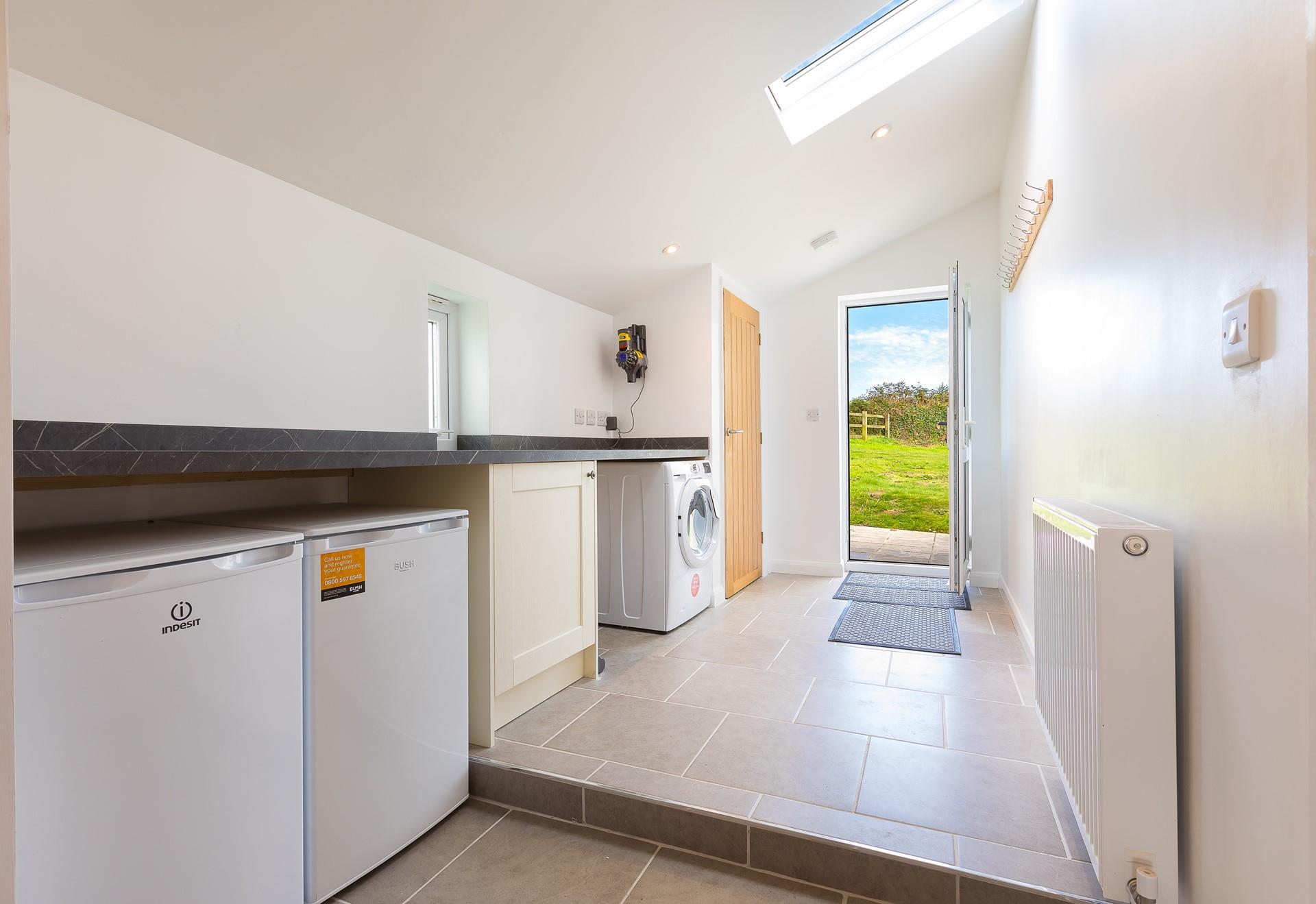 The convenient and spacious utility area has a washer/dryer, below counter fridge and separate freezer.