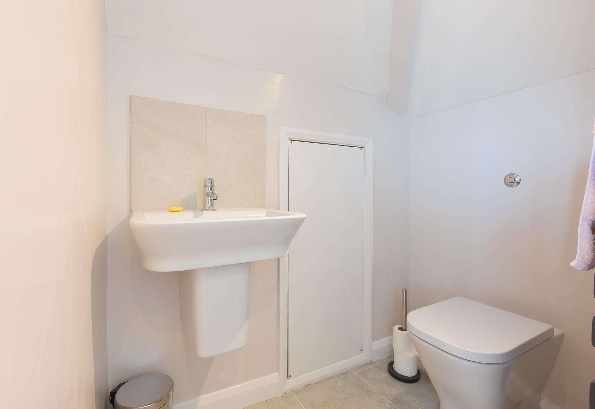 Bedroom 1 has a convenient ensuite cloakroom with WC and washbasin.