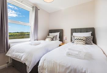 Sumptuous twin beds benefit from views overlooking the rolling countryside.