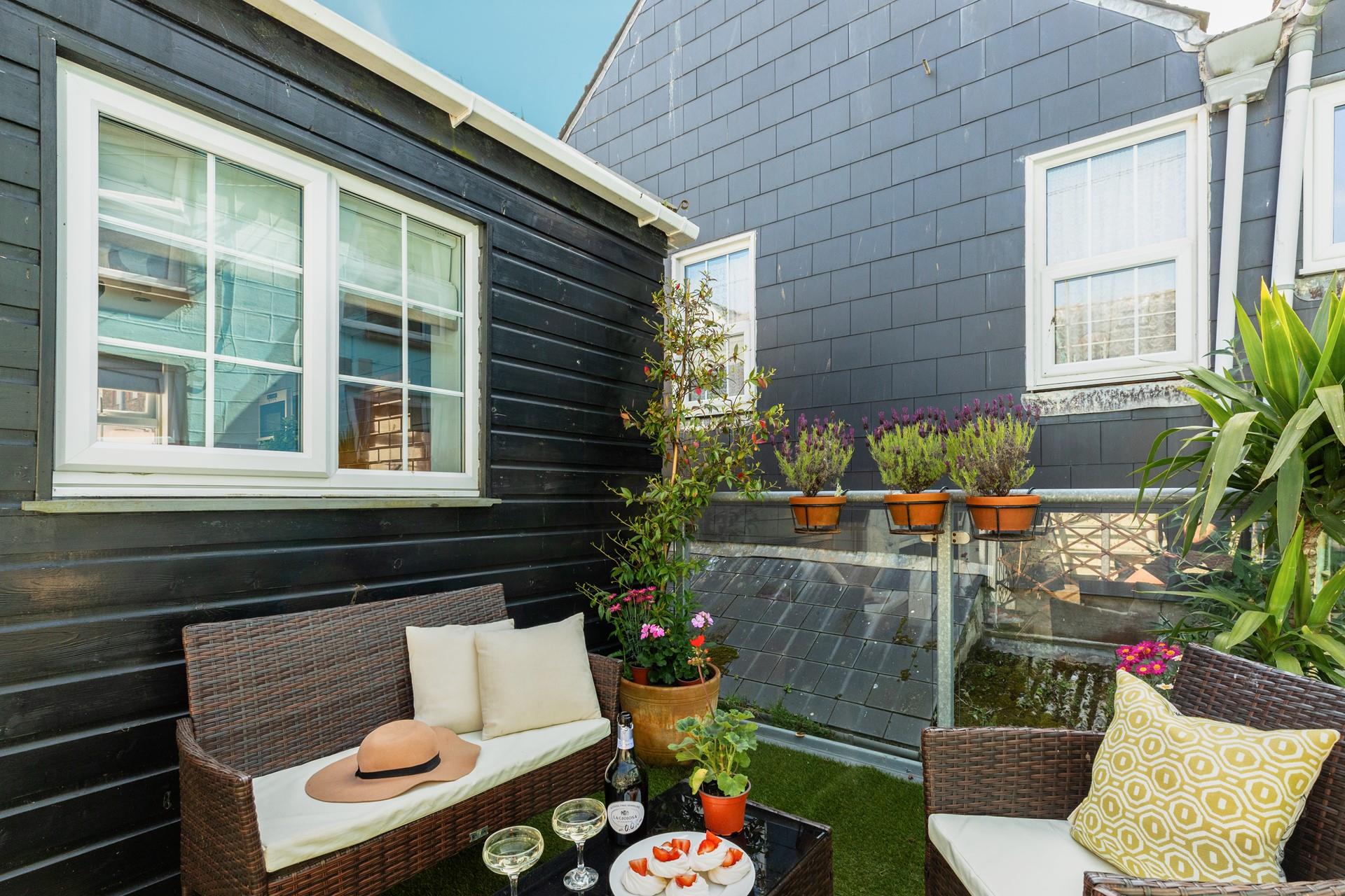 Catch the last of the sunshine on the terrace, relaxing on the lovely rattan furniture.