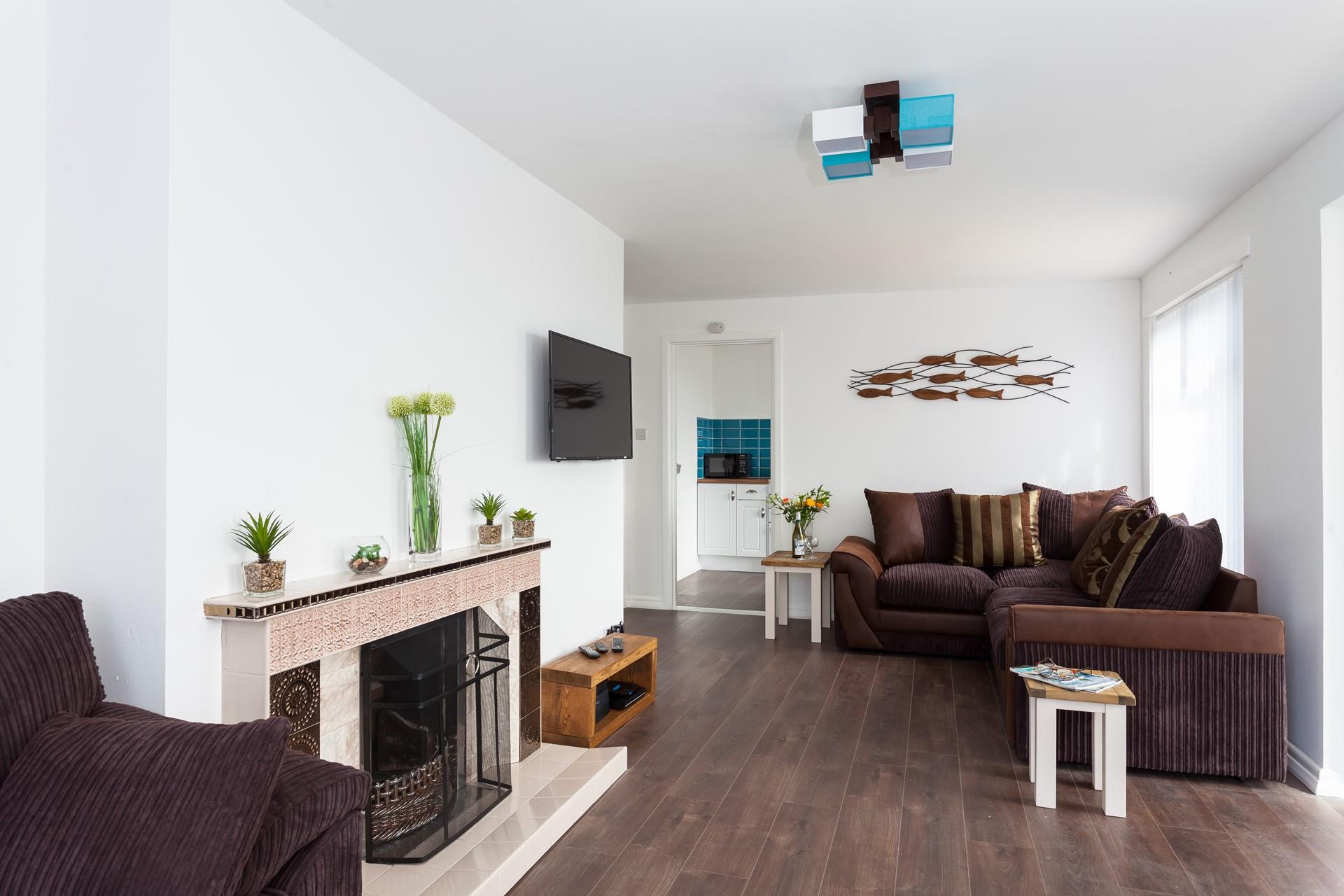 Relax and unwind in this spacious living area, the property has an open fire for chilly evenings.