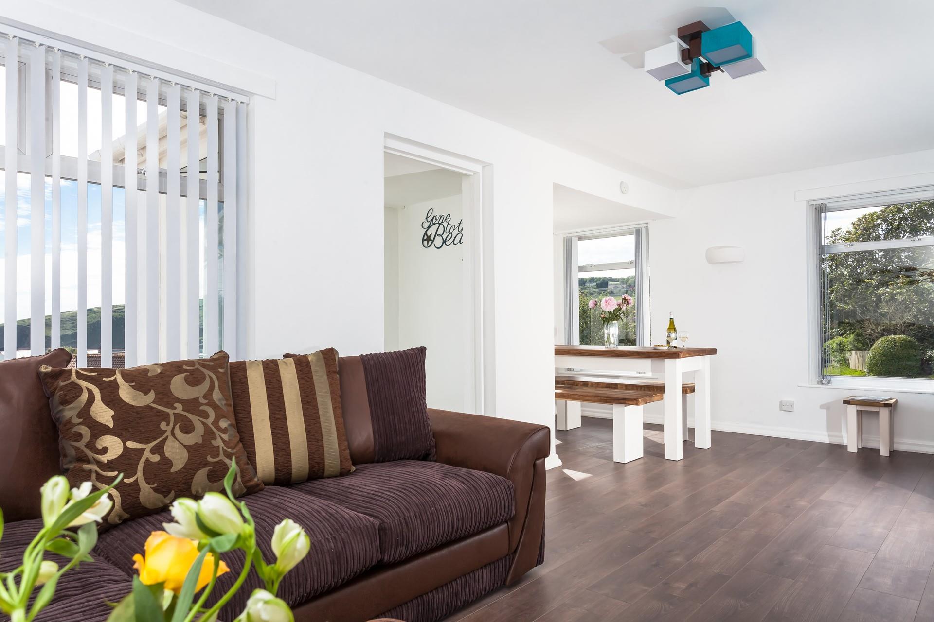 Earthy tones mixed with seaside hues give the living area a comforting and cosy feel while reminding you how close to the sea you are.