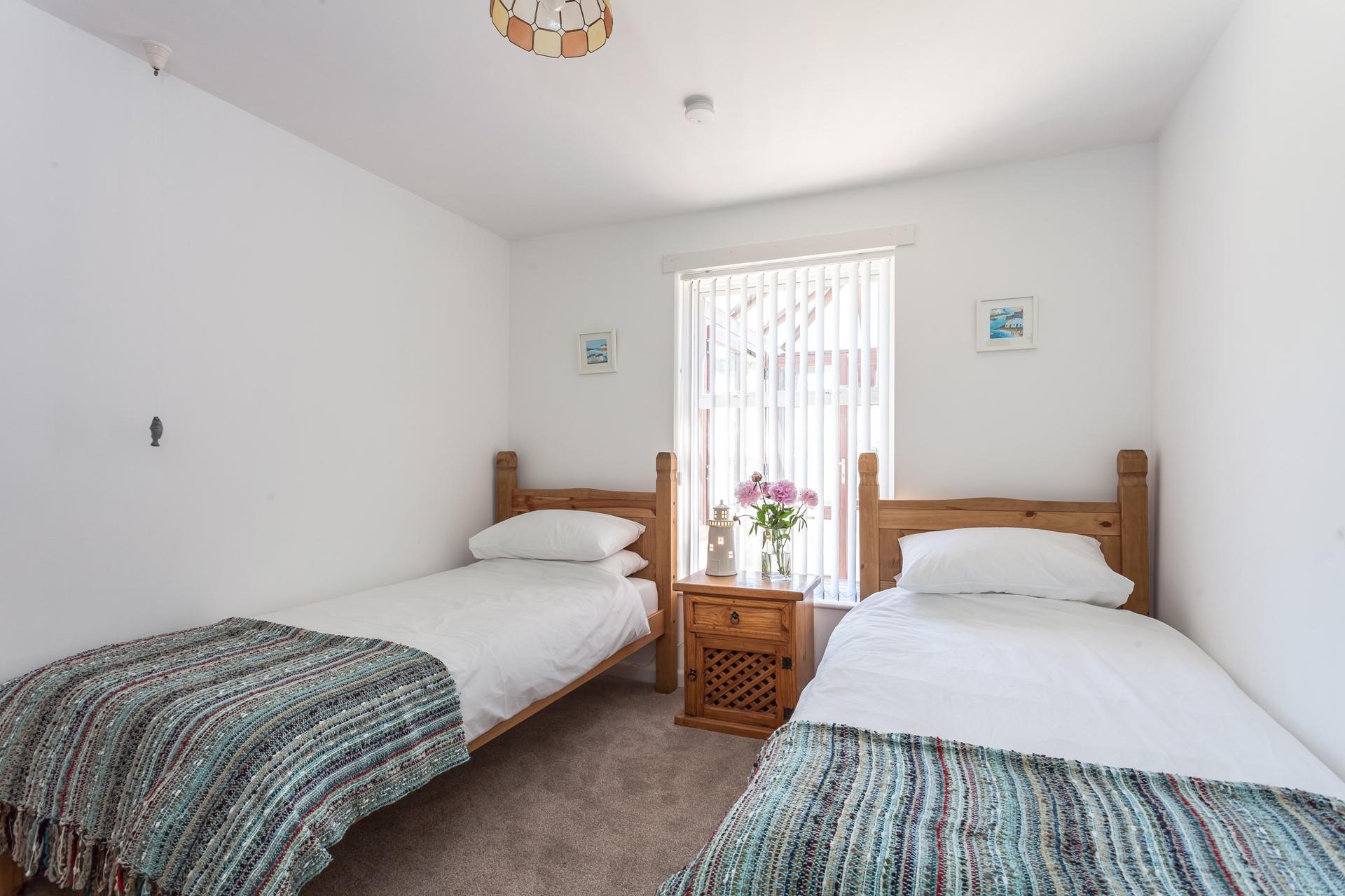 Bedroom two is complete with two single beds allowing this to be the perfect property for a family holiday by the sea.