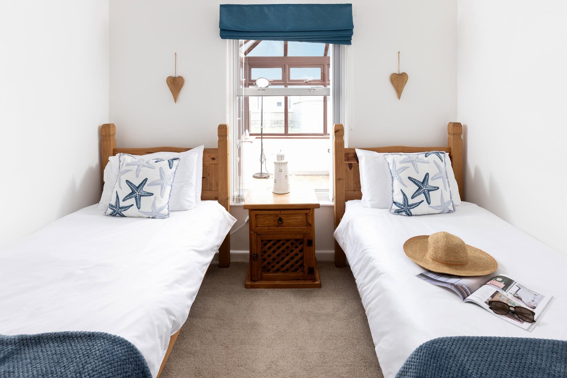 Bedroom two is complete with two single beds allowing this to be the perfect property for a family holiday by the sea.