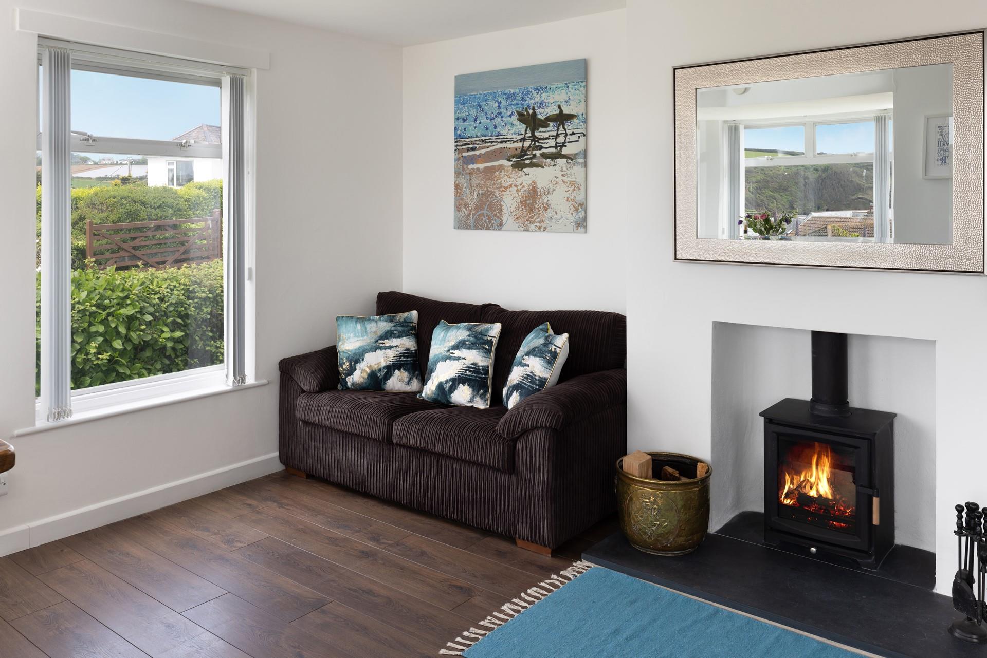 The two-seater sofa is situated in the sun trap by the window, creating the perfect space to relax with a good book.