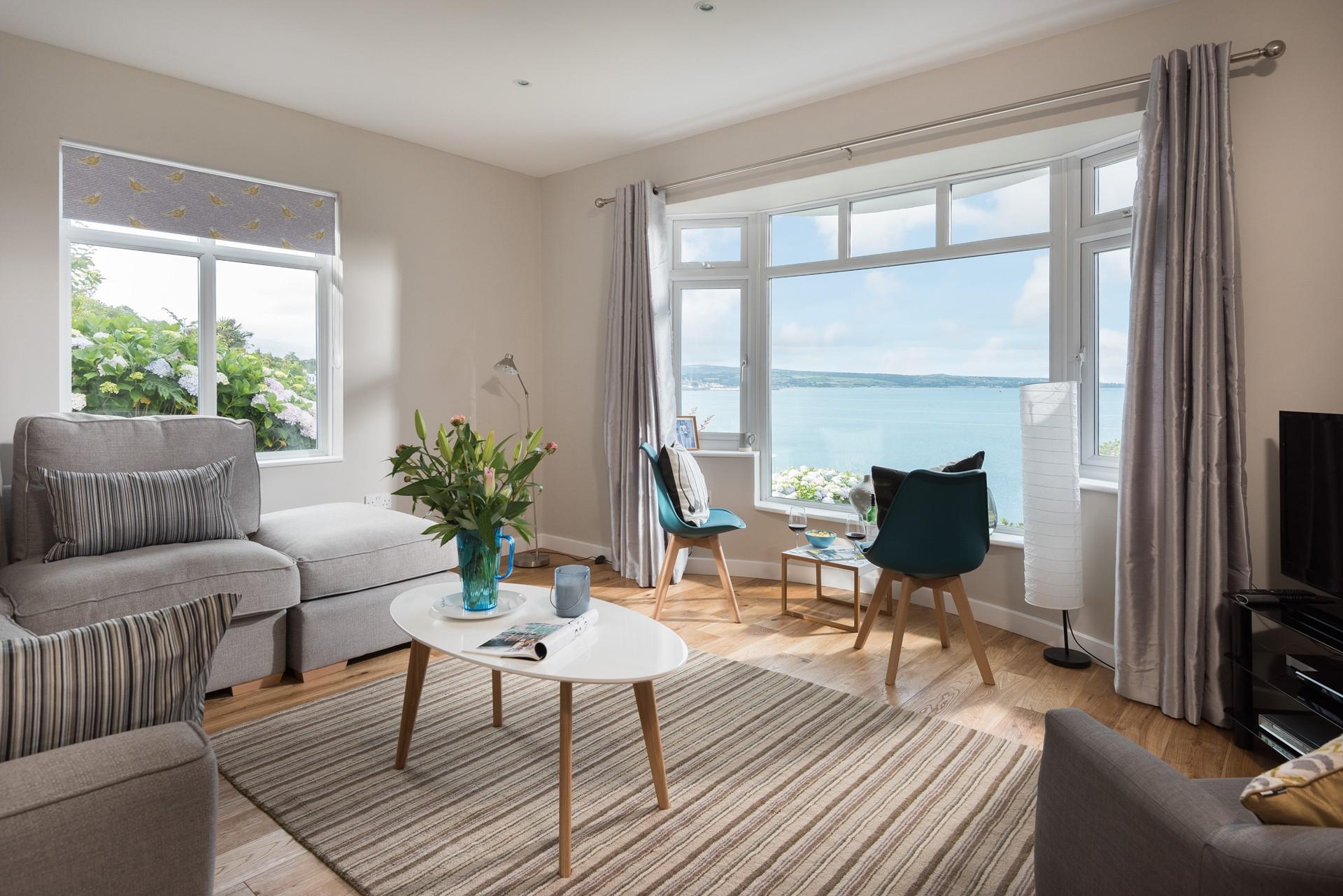 The cosy sitting room has captivating sea views to enjoy with a glass of wine.