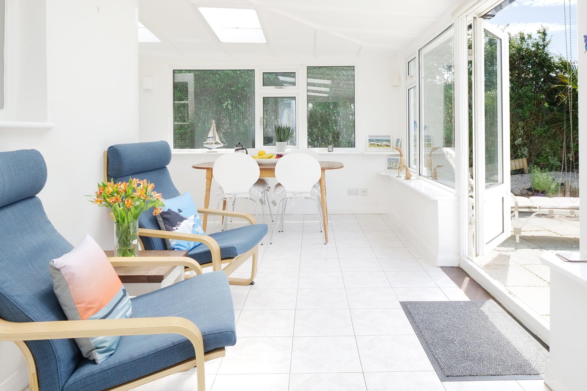 Sip a cold drink in the sunroom after a day on Widemouth Bay beach.