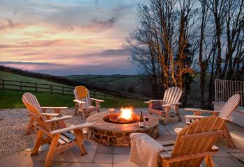 Gather around the fire pit with a drink as the sun goes down in the evening.