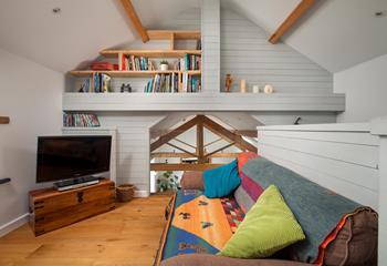 Relax on the sofa or beanbag with a book or a film in this lovely additional mezzanine snug area.