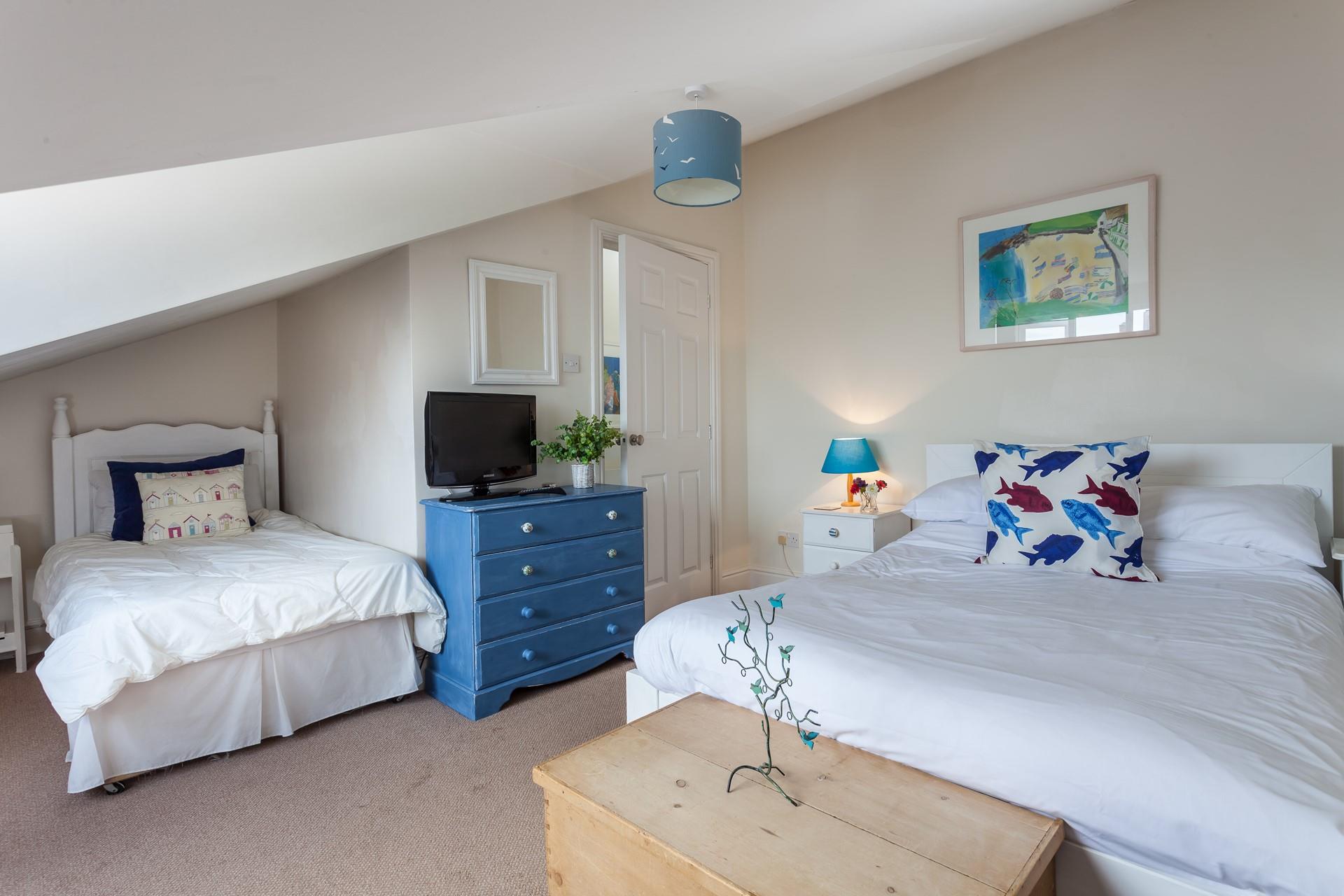 Bedroom 2 is decorated with blue and white, creating a calming space to relax.