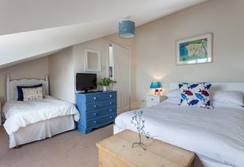 Bedroom 2 is decorated with blue and white, creating a calming space to relax.