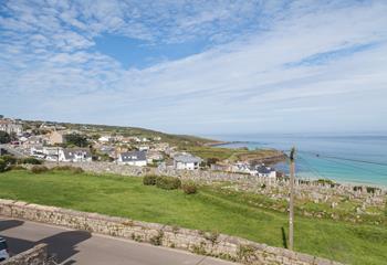 A panoramic view across St Ives town and miles of beautiful blue ocean and coastline.