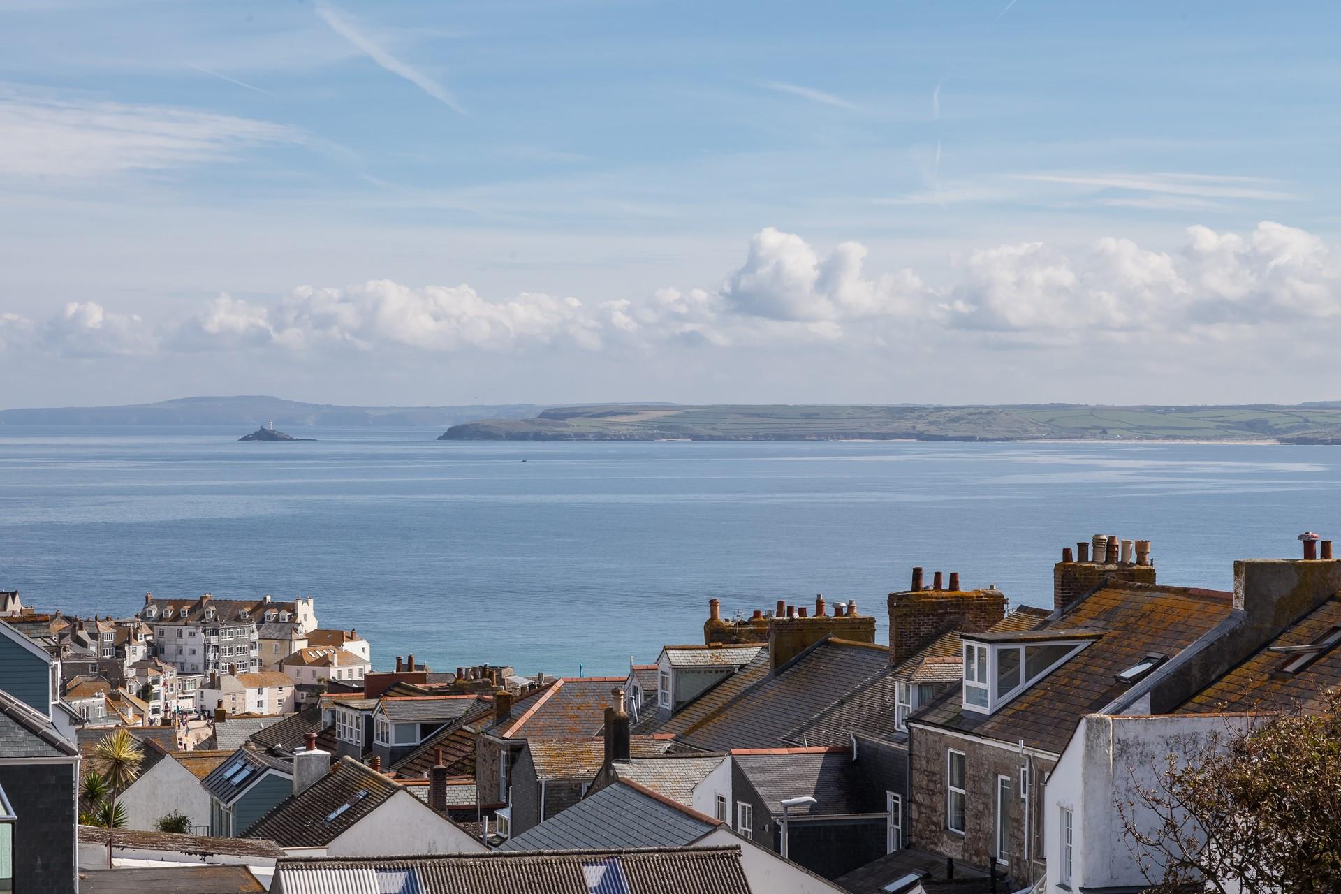 Gaze across St Ives' rooftops as far as Godrevy Lighthouse.