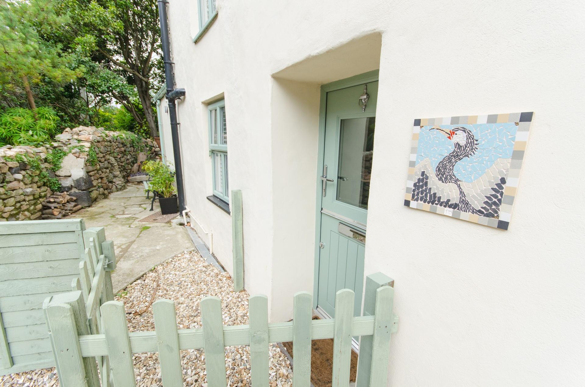 A quaint and welcoming arrival awaits at Cormorant cottage.