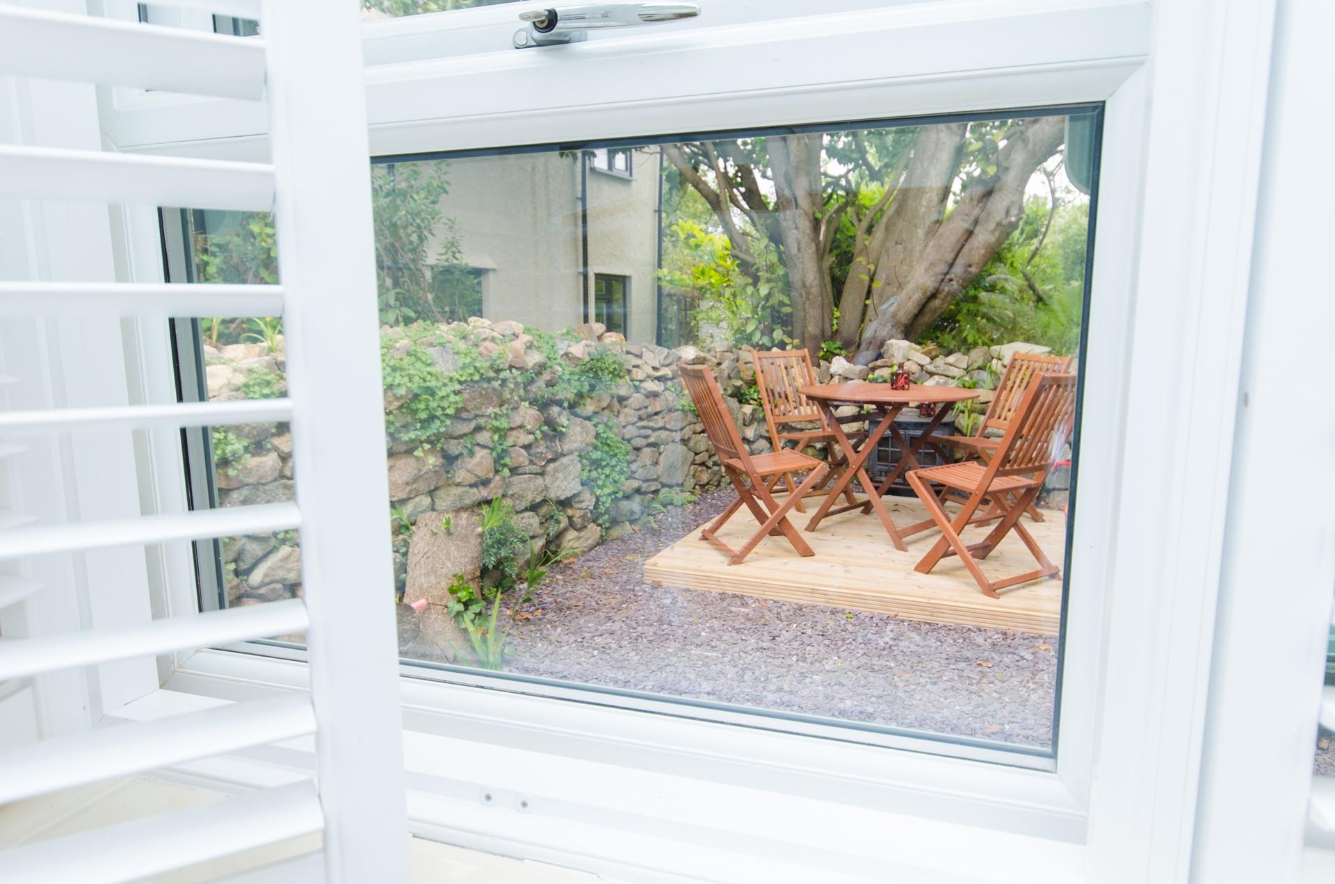 The kitchen window overlooks the quaint courtyard garden.