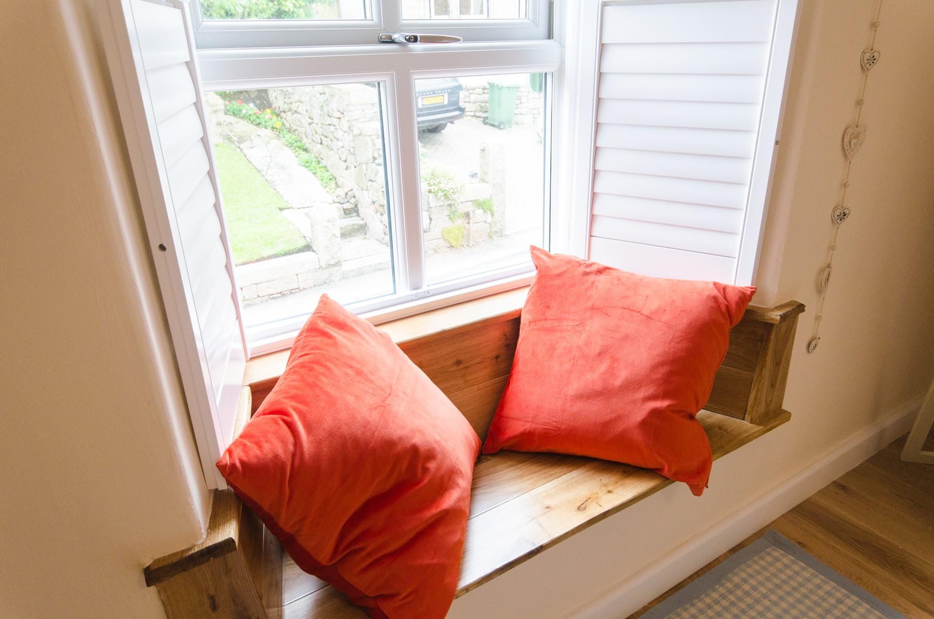 The window seat offers a peaceful reading spot.
