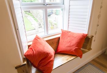 The window seat offers a peaceful reading spot.