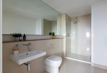 The en suite is ultra-sleek and modern, offering extra space and privacy.