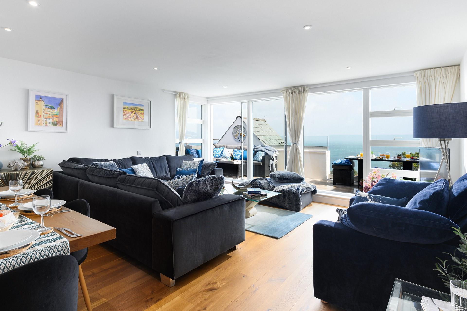 This beautifully designed living room will make you feel relaxed with the blue horizon claiming the backdrop.