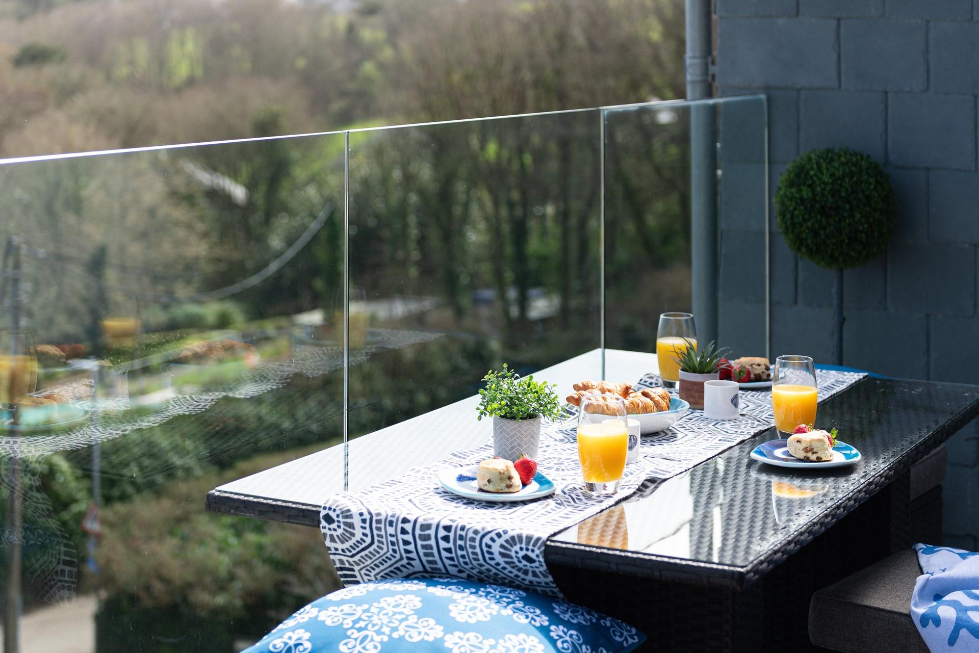 Tuck into an al fresco afternoon tea on the balcony in the summer sun.