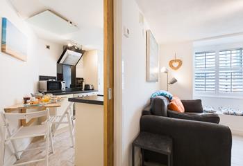 A solid oak sliding door separates the kitchen and dining area from the living space.