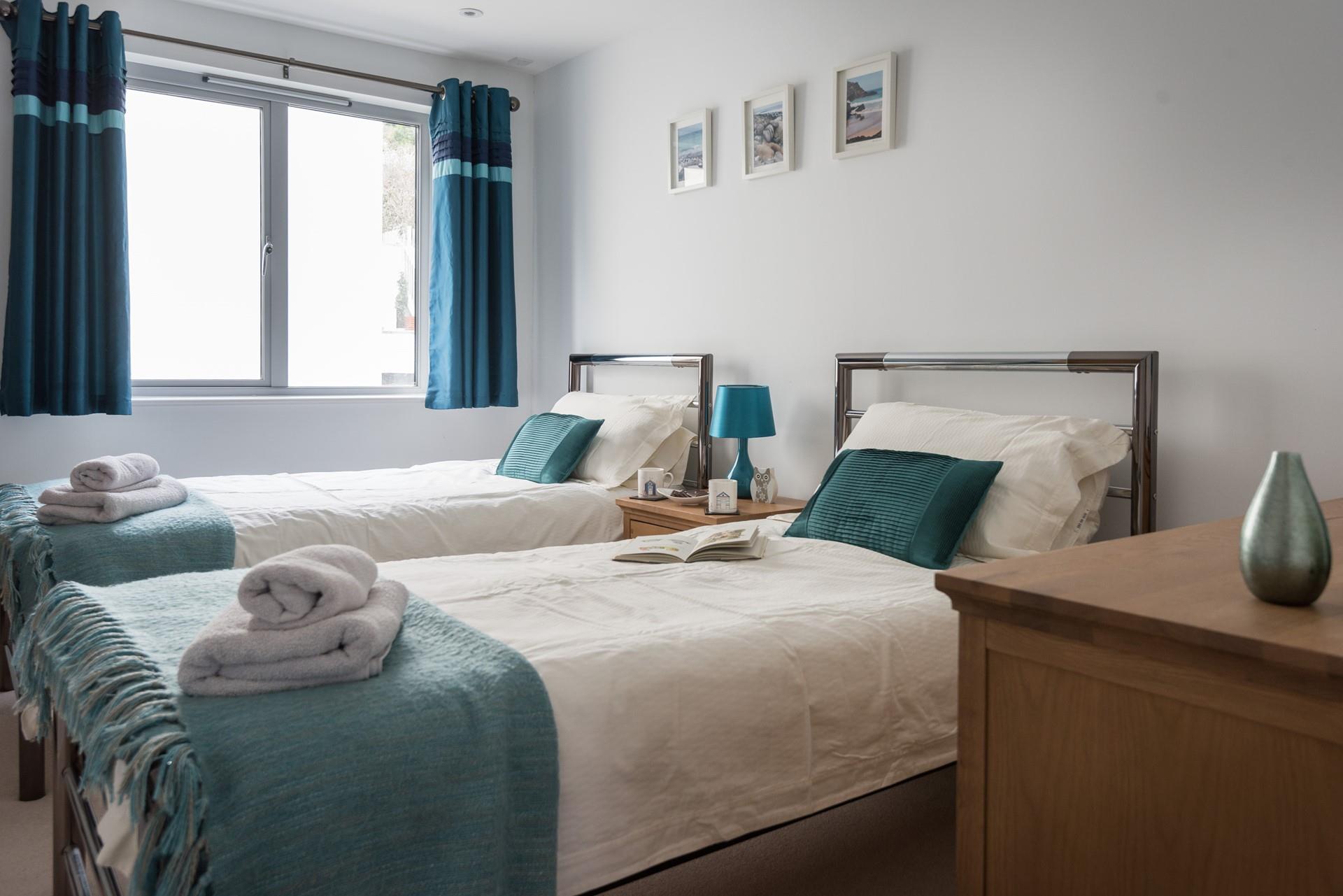 Bedroom 2 at the rear of the apartment offers twin beds and plenty of storage for all your holiday attire. 