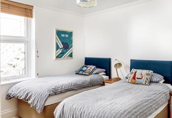 The twin beds are perfect for adults or children and have a seaside theme.