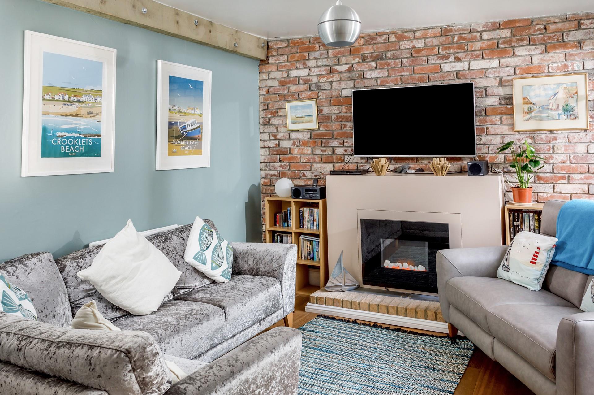 The sitting room is comfortable and features Bude-inspired artwork on the walls.