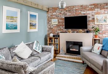 The sitting room is comfortable and features Bude-inspired artwork on the walls.
