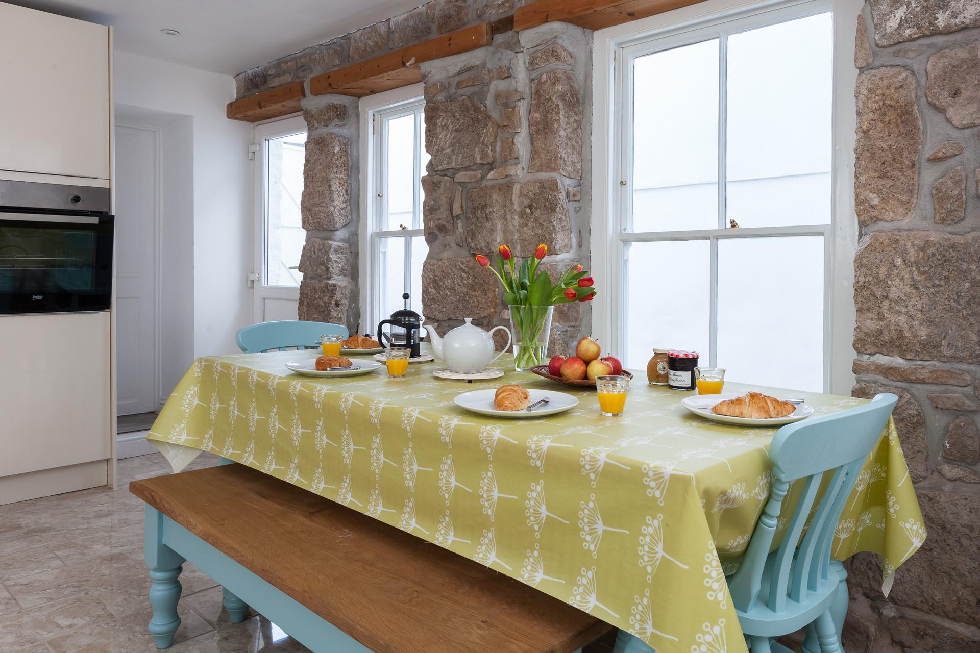 An exposed stone feature wall adds some Cornish character to the kitchen.